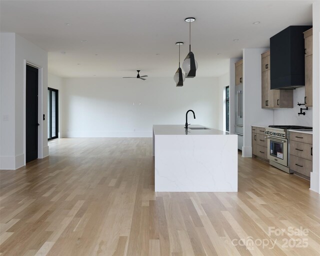 1511 Waverly Ave, Charlotte, NC 28203 - kitchen with high end stainless steel range, ceiling fan, and light wood-style flooring