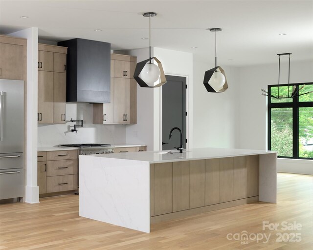 1511 Waverly Ave, Charlotte, NC 28203 - kitchen with stainless steel appliances, light wood-style floors, wall chimney range hood, light countertops, and modern cabinets