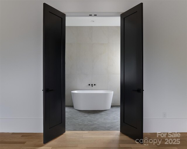 1511 Waverly Ave, Charlotte, NC 28203 - full bathroom featuring a freestanding bath and tile walls