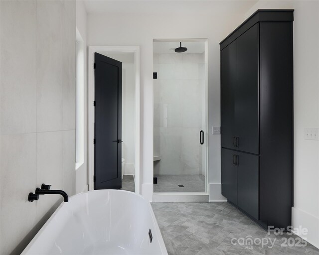 1511 Waverly Ave, Charlotte, NC 28203 - bathroom with a stall shower and a freestanding tub