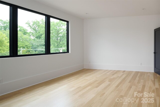 1511 Waverly Ave, Charlotte, NC 28203 - spare room with light wood-style flooring and baseboards