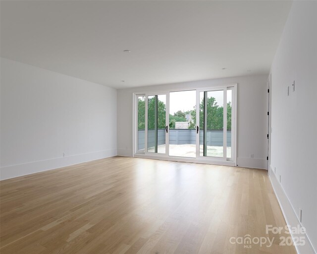 1511 Waverly Ave, Charlotte, NC 28203 - empty room featuring light wood-style floors and baseboards