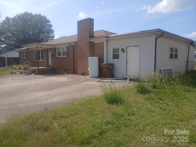 2815 Highland Dr, Lincolnton, NC 28092 - view of front of home with a chimney, brick siding, and covered porch