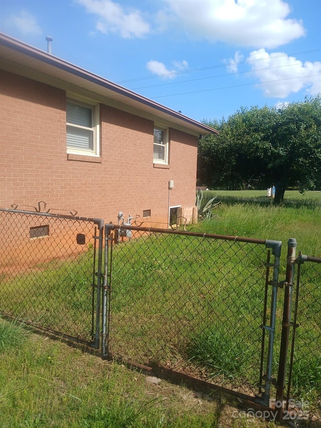 2815 Highland Dr, Lincolnton, NC 28092 - view of side of property with a gate, crawl space, and brick siding