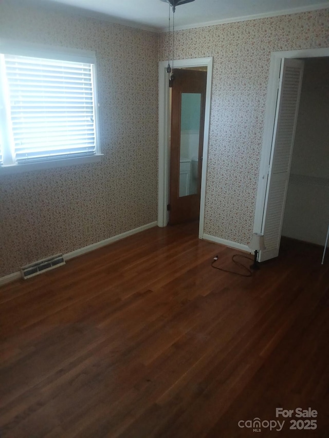 2815 Highland Dr, Lincolnton, NC 28092 - unfurnished room with dark wood-style floors and wallpapered walls