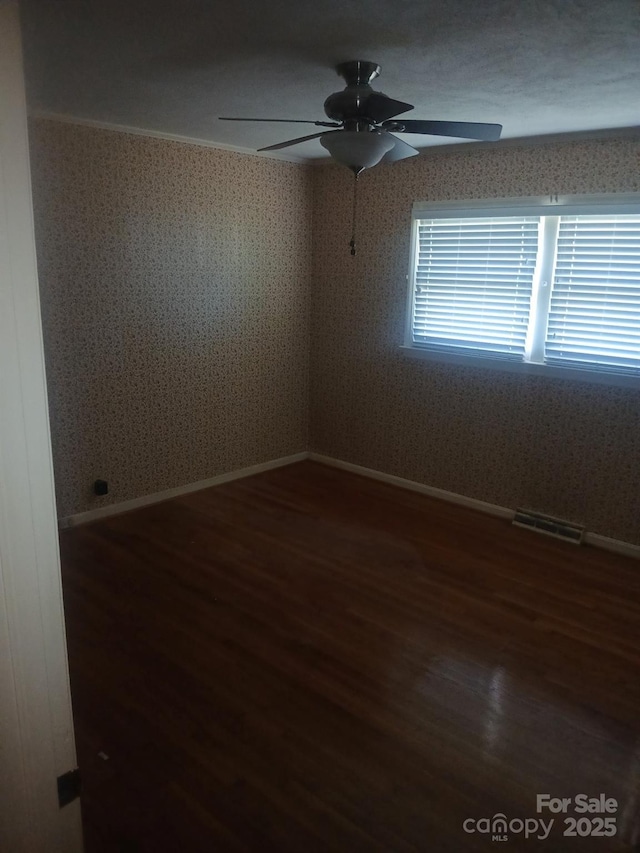 2815 Highland Dr, Lincolnton, NC 28092 - spare room featuring a ceiling fan, wood finished floors, and wallpapered walls