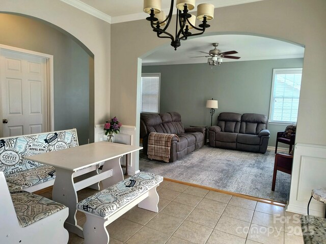 10825 Traders Ct, Davidson, NC 28036 - living room with arched walkways, light carpet, ornamental molding, light tile patterned floors, and ceiling fan