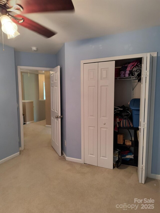 10825 Traders Ct, Davidson, NC 28036 - bedroom featuring light carpet, a closet, and ceiling fan