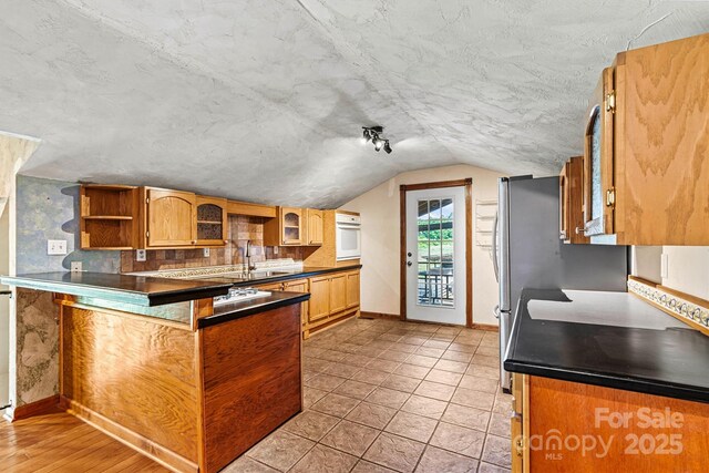3724 County Home Rd, Conover, NC 28613 - kitchen featuring a peninsula, glass insert cabinets, lofted ceiling, dark countertops, and oven