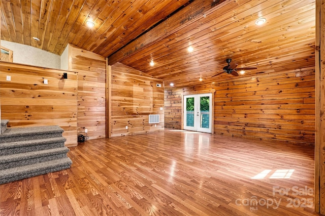 3724 County Home Rd, Conover, NC 28613 - unfurnished living room featuring lofted ceiling, wood finished floors, stairway, wooden walls, and wood ceiling