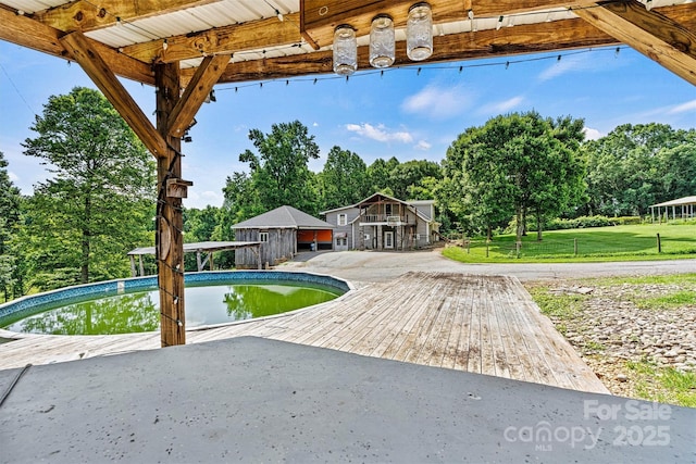 3724 County Home Rd, Conover, NC 28613 - view of front of home with an outdoor pool, view of scattered trees, a front lawn, and a patio