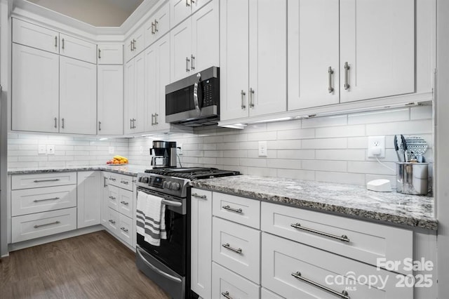 4210 Holly Cir NE, Conover, NC 28613 - kitchen with appliances with stainless steel finishes, white cabinets, light stone countertops, and dark wood-type flooring