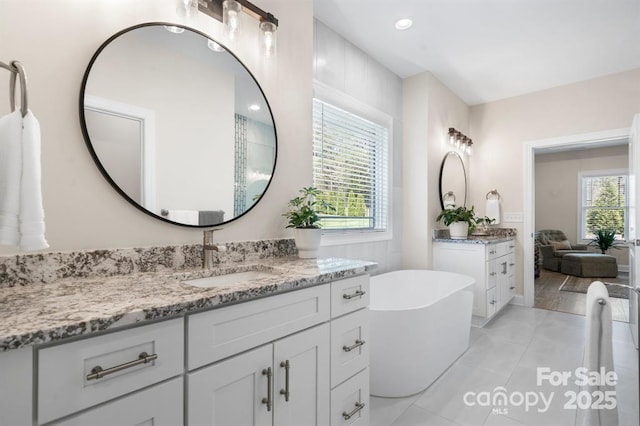 4210 Holly Cir NE, Conover, NC 28613 - bathroom with two vanities, a soaking tub, and tile patterned floors