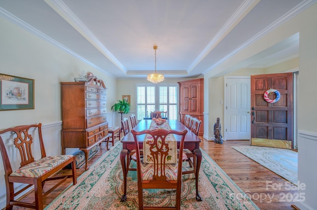8 Creekside Way, Asheville, NC 28804 - dining space featuring light wood-style flooring, crown molding, and a raised ceiling