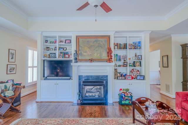 8 Creekside Way, Asheville, NC 28804 - living room featuring wood finished floors, ceiling fan, a premium fireplace, ornamental molding, and built in shelves