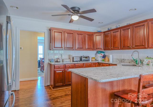 8 Creekside Way, Asheville, NC 28804 - kitchen featuring a ceiling fan, a breakfast bar, stainless steel refrigerator, light stone countertops, and light wood finished floors