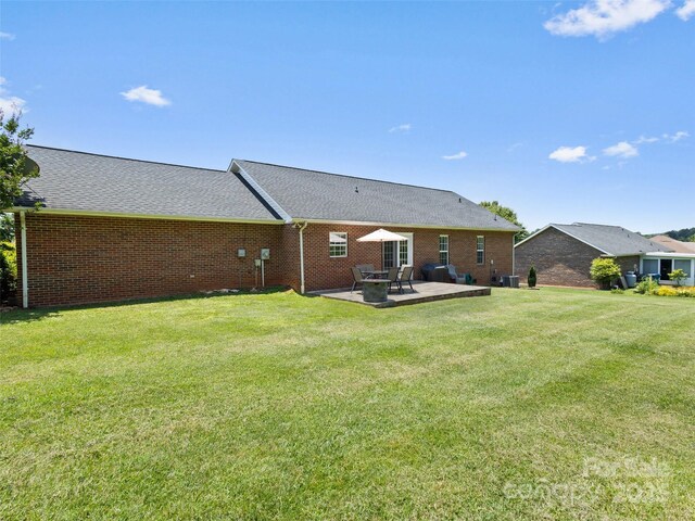 3906 Brickfield St, Hickory, NC 28602 - rear view of property featuring a yard, a patio, and brick siding