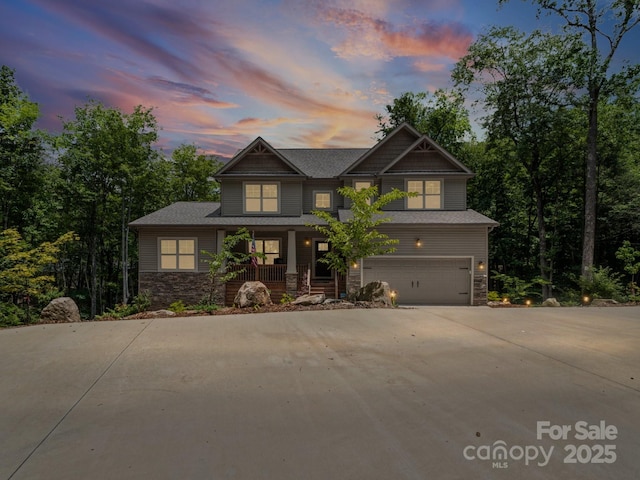 714 Bolt Rd, Lake Lure, NC 28746 - craftsman inspired home featuring stone siding, covered porch, a garage, and concrete driveway