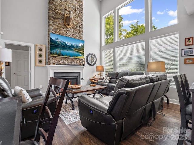 714 Bolt Rd, Lake Lure, NC 28746 - living room featuring a high ceiling, dark wood finished floors, a lit fireplace, and plenty of natural light