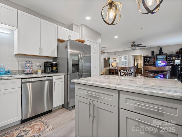 714 Bolt Rd, Lake Lure, NC 28746 - kitchen featuring appliances with stainless steel finishes, ceiling fan, light wood-style floors, recessed lighting, and light stone countertops