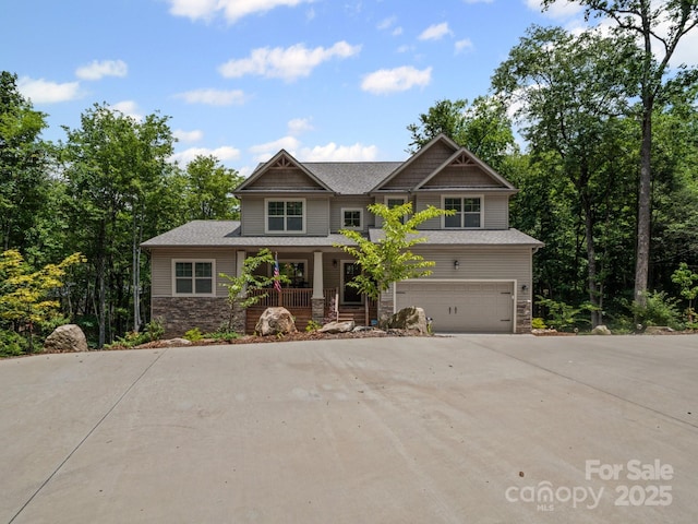 714 Bolt Rd, Lake Lure, NC 28746 - craftsman inspired home with covered porch, stone siding, concrete driveway, and an attached garage