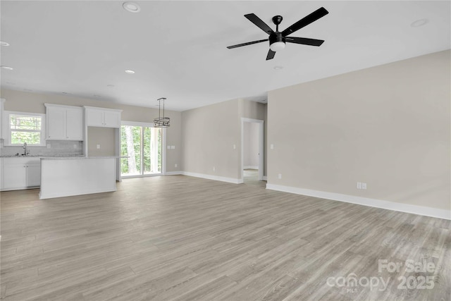 222 Elm St, Mocksville, NC 27028 - unfurnished living room with plenty of natural light, recessed lighting, a ceiling fan, and light wood-type flooring