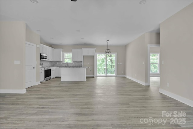222 Elm St, Mocksville, NC 27028 - unfurnished living room featuring light wood finished floors and baseboards