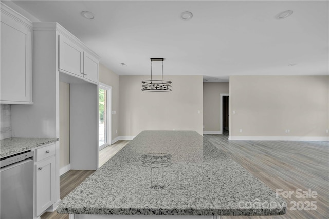 222 Elm St, Mocksville, NC 27028 - kitchen with stainless steel dishwasher, light wood finished floors, white cabinets, open floor plan, and light stone countertops