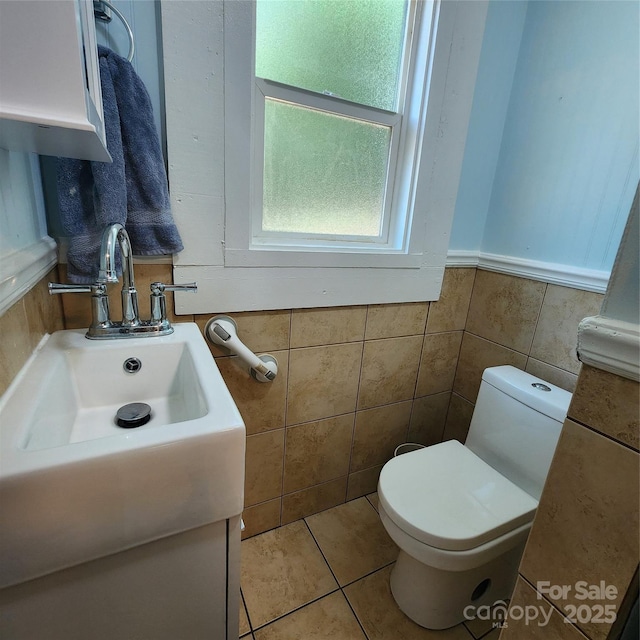703/705 Smith St, Kannapolis, NC 28083 - bathroom featuring tile walls, tile patterned floors, a wainscoted wall, and vanity