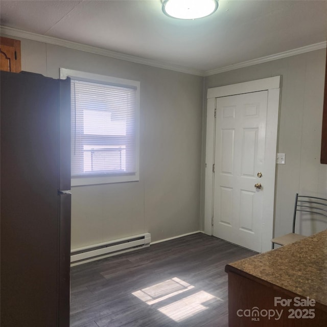 703/705 Smith St, Kannapolis, NC 28083 - unfurnished dining area featuring a baseboard radiator, dark wood-style flooring, and crown molding
