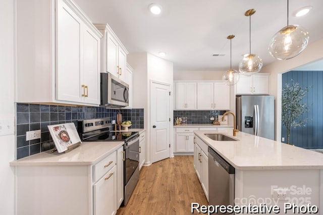 622 Station St Unit 48, Clover, SC 29710 - kitchen featuring stainless steel appliances, white cabinetry, light wood-type flooring, a center island with sink, and recessed lighting