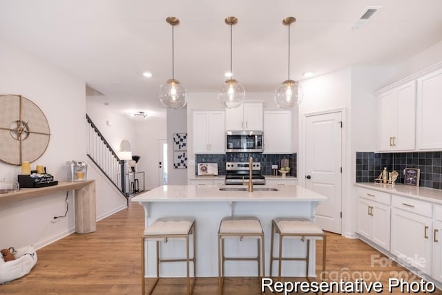 622 Station St Unit 48, Clover, SC 29710 - kitchen featuring appliances with stainless steel finishes, a breakfast bar, tasteful backsplash, light countertops, and recessed lighting