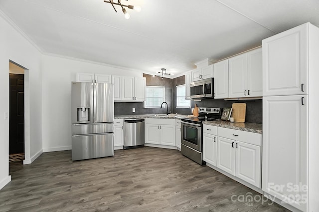 1778 N Ingleside Farm Rd, Iron Station, NC 28080 - kitchen featuring stainless steel appliances, white cabinetry, dark wood finished floors, crown molding, and tasteful backsplash
