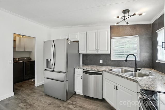 1778 N Ingleside Farm Rd, Iron Station, NC 28080 - kitchen featuring stainless steel appliances, separate washer and dryer, ornamental molding, dark wood-style floors, and white cabinets