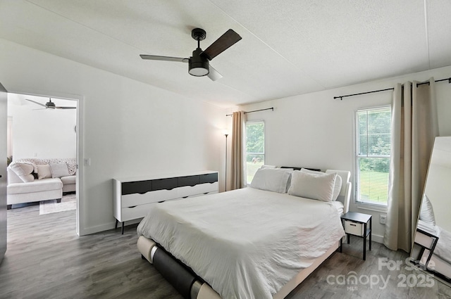 1778 N Ingleside Farm Rd, Iron Station, NC 28080 - bedroom with multiple windows, wood finished floors, a textured ceiling, and ceiling fan