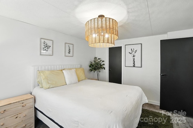 1778 N Ingleside Farm Rd, Iron Station, NC 28080 - bedroom featuring wood finished floors and a chandelier