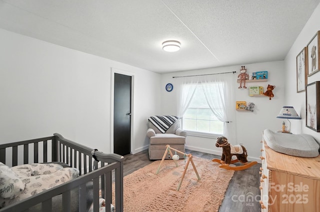 1778 N Ingleside Farm Rd, Iron Station, NC 28080 - bedroom featuring wood finished floors, a textured ceiling, and a nursery area