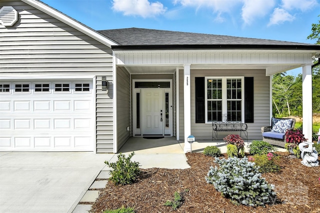 255 Eagles Lndg, Morganton, NC 28655 - doorway to property with covered porch, a shingled roof, a garage, and concrete driveway
