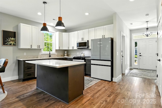 255 Eagles Lndg, Morganton, NC 28655 - kitchen with freestanding refrigerator, white cabinetry, dark wood-type flooring, decorative light fixtures, and recessed lighting