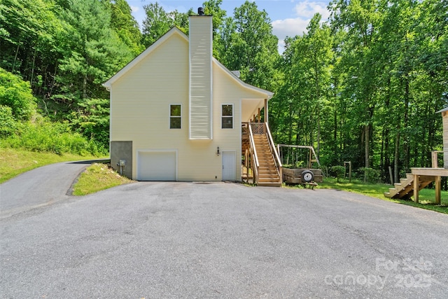 222 Fox Creek Rd, Mars Hill, NC 28754 - view of property exterior with stairs, driveway, a chimney, and a garage