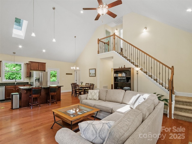 222 Fox Creek Rd, Mars Hill, NC 28754 - living area with stairs, high vaulted ceiling, light wood-style floors, a chandelier, and ceiling fan