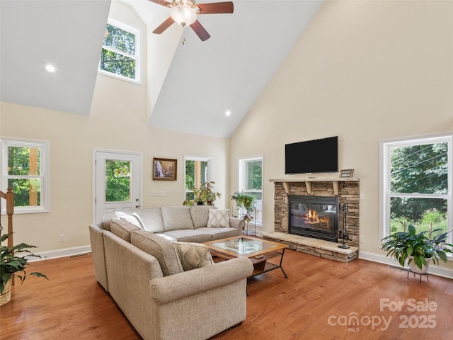 222 Fox Creek Rd, Mars Hill, NC 28754 - living room with high vaulted ceiling, ceiling fan, a stone fireplace, and wood finished floors