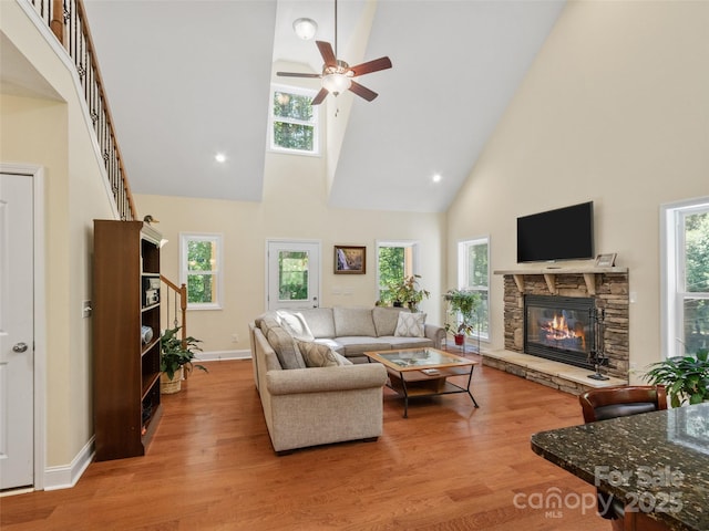 222 Fox Creek Rd, Mars Hill, NC 28754 - living room with high vaulted ceiling, a ceiling fan, a stone fireplace, and light wood finished floors