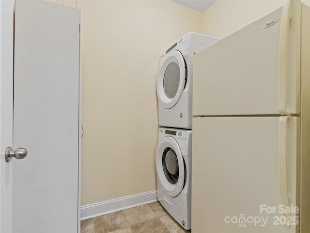 222 Fox Creek Rd, Mars Hill, NC 28754 - laundry room featuring stacked washer and clothes dryer and baseboards