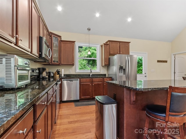 222 Fox Creek Rd, Mars Hill, NC 28754 - kitchen featuring appliances with stainless steel finishes, a breakfast bar area, light wood-style floors, glass insert cabinets, and pendant lighting
