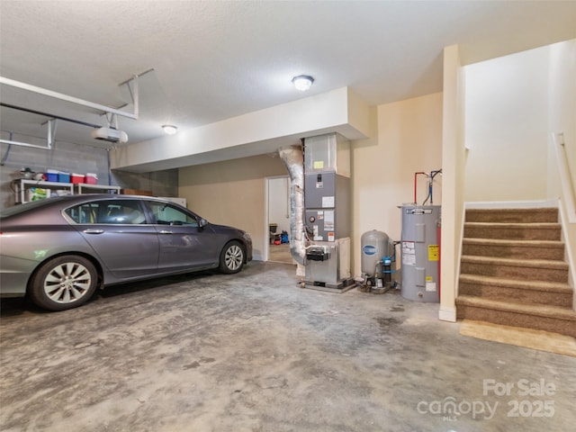 222 Fox Creek Rd, Mars Hill, NC 28754 - garage with electric water heater, a garage door opener, and heating unit