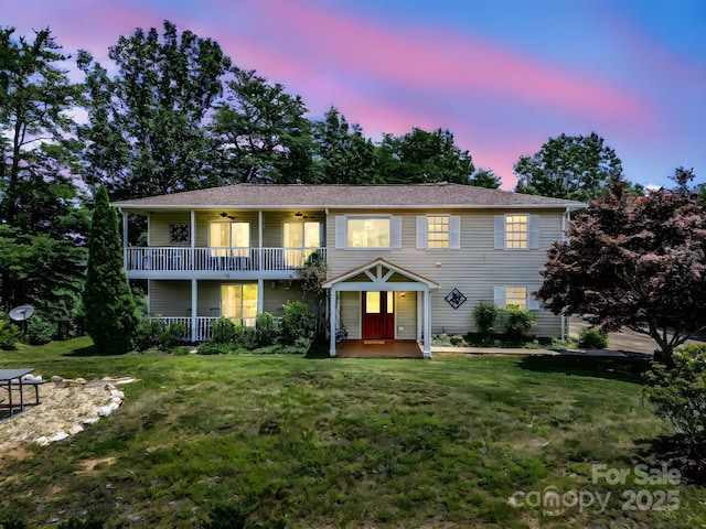 198 Sugarbush Pt, Lake Lure, NC 28746 - view of front of house featuring a balcony, a ceiling fan, and a lawn