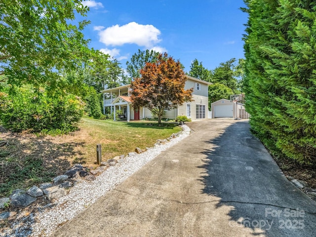 198 Sugarbush Pt, Lake Lure, NC 28746 - view of property hidden behind natural elements with an outdoor structure, a garage, a front lawn, and driveway