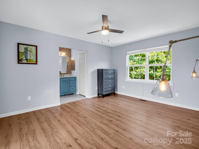 198 Sugarbush Pt, Lake Lure, NC 28746 - unfurnished bedroom with wood finished floors, ensuite bathroom, and a ceiling fan
