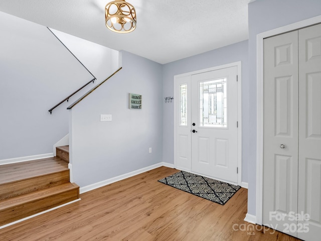 198 Sugarbush Pt, Lake Lure, NC 28746 - foyer with stairway and wood finished floors